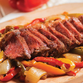 Grilled New York Strip steak with Spanish peppers