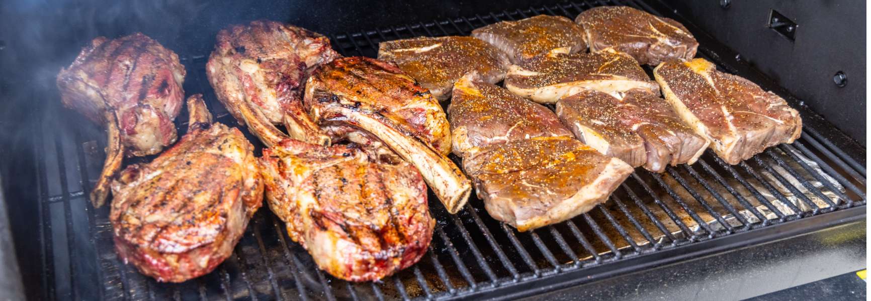 Juicy steaks cooking on a grill